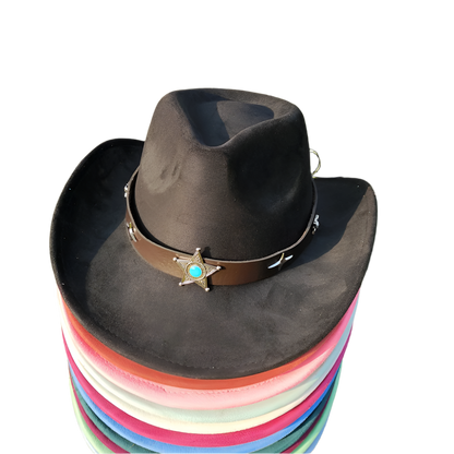Stack of colorful hats with a black cowboy hat on top on grass