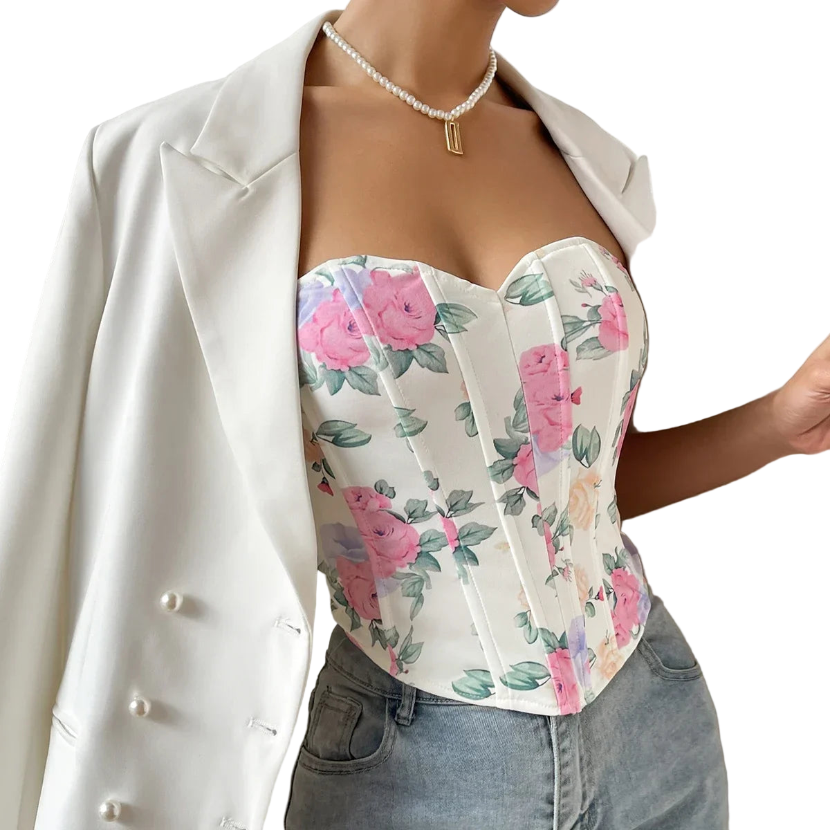 Person wearing a floral top and white blazer with a neutral background