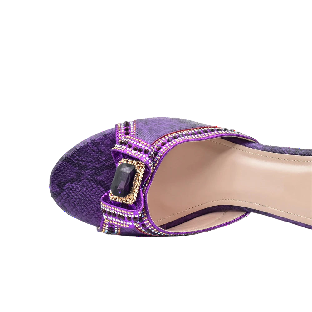 Purple shoe with embellishments on a white background