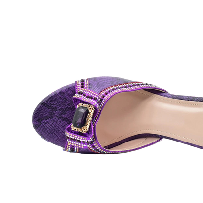 Purple shoe with embellishments on a white background