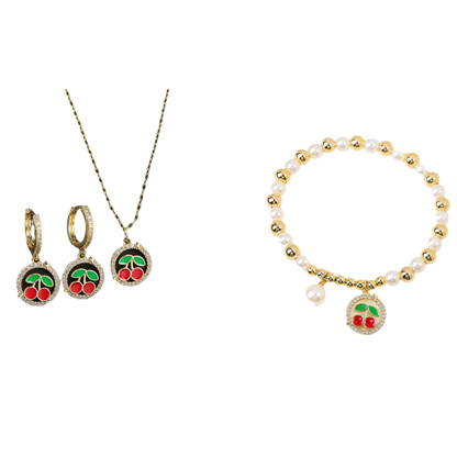 Jewelry set with cherry-themed earrings, necklace, and bracelet on a black and white background.