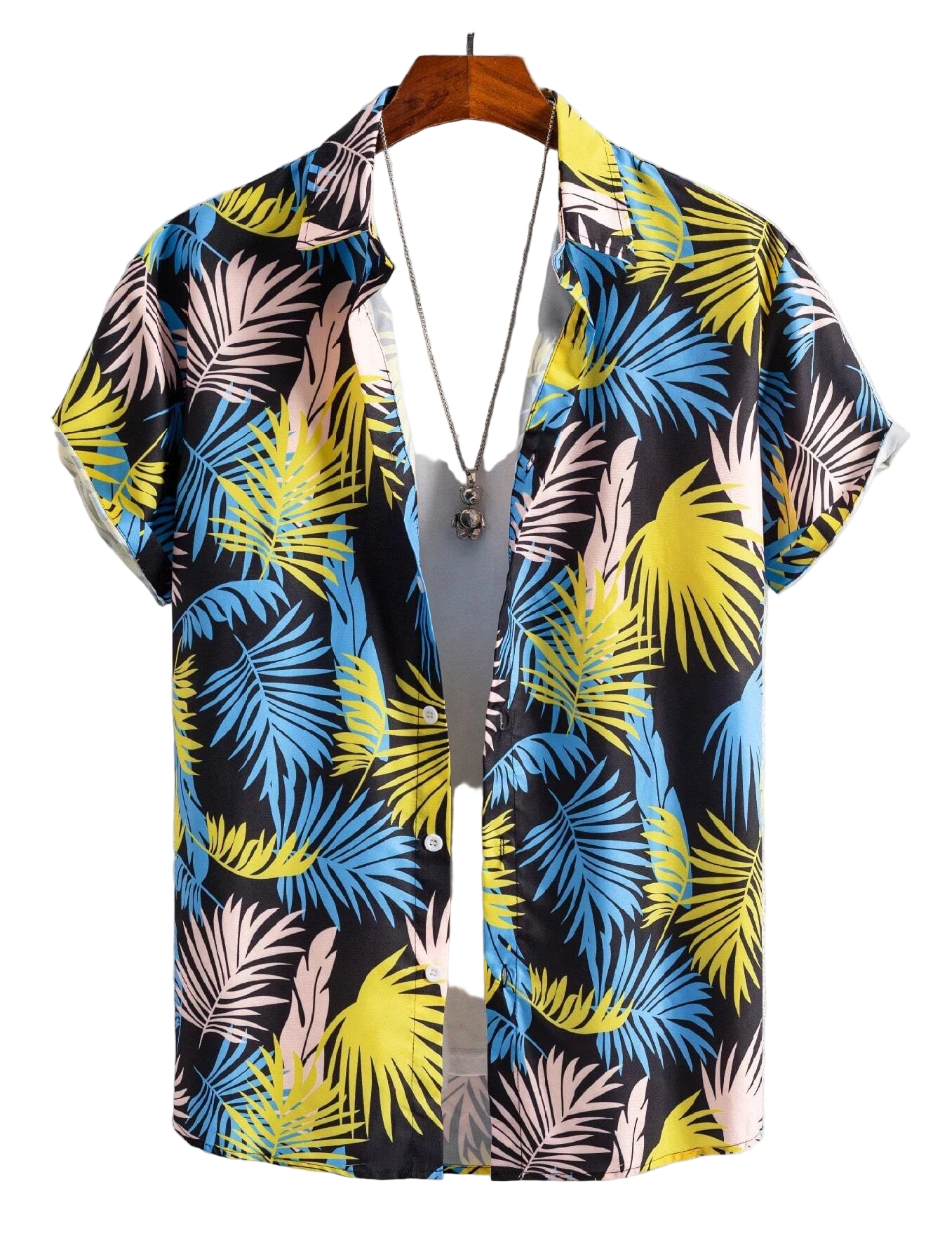 Colorful tropical leaf patterned shirt on a hanger against a white background