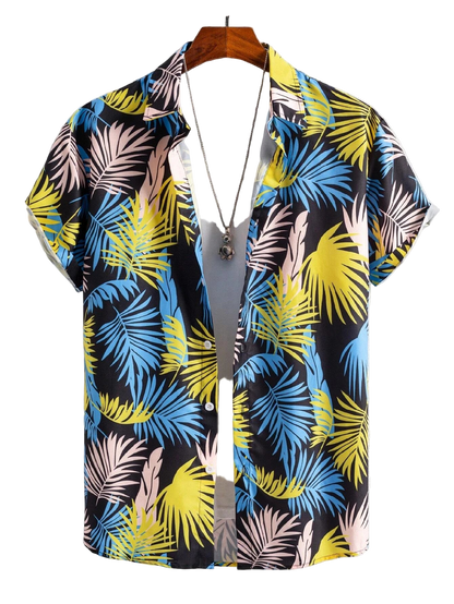 Colorful tropical leaf patterned shirt on a hanger against a white background