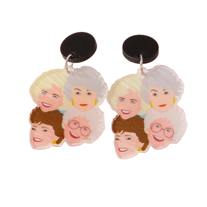 Earrings with cartoon-like faces of elderly women on a beige background
