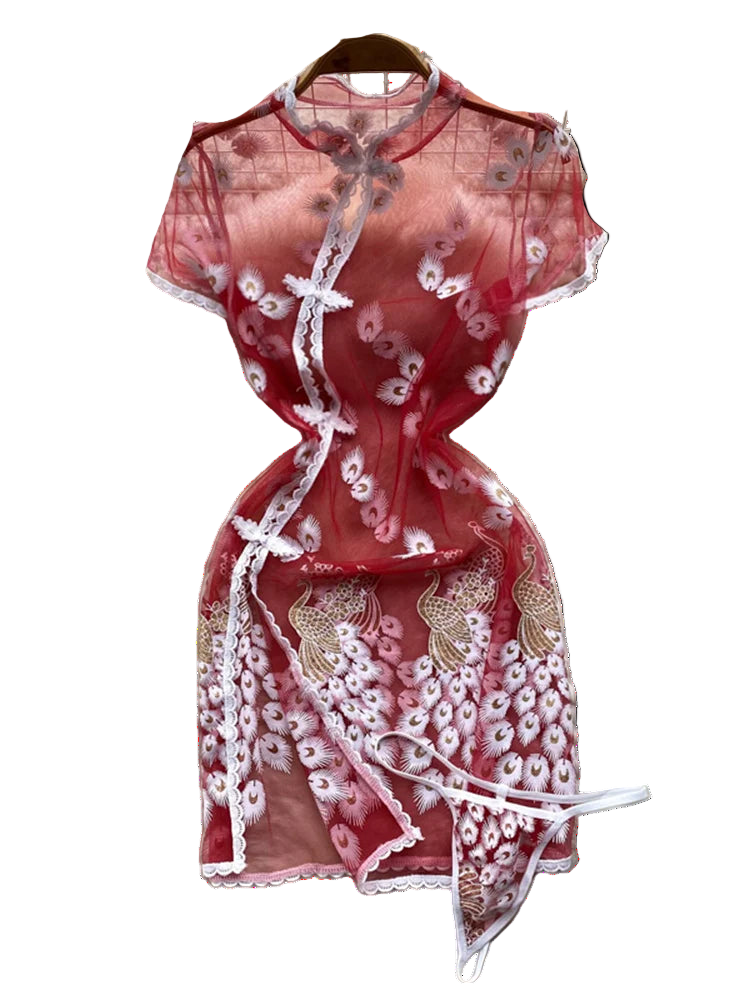 Red lace dress on a white fur surface with floral decorations in the background