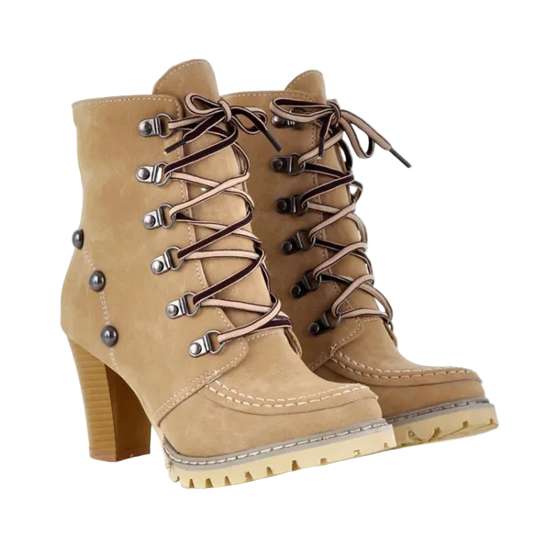 A pair of beige suede lace-up ankle boots with a chunky block heel, silver metal eyelets, and brown laces, shown on a white background.