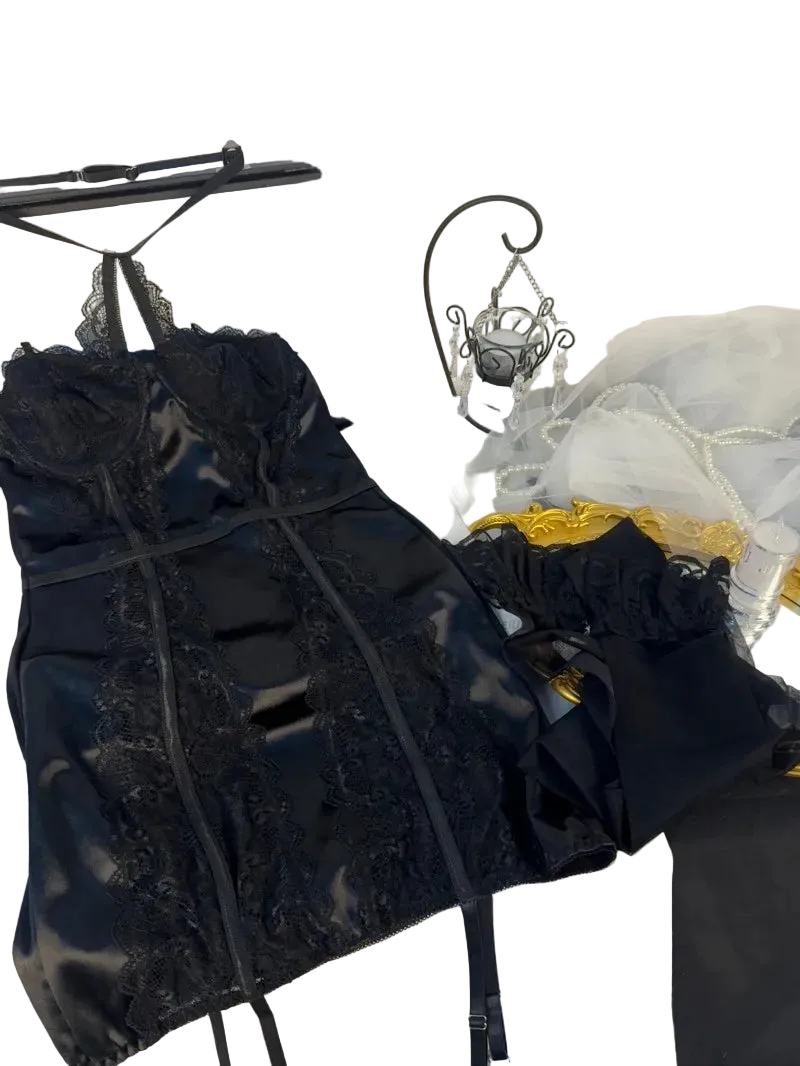 Black lace top on a hanger with a white background