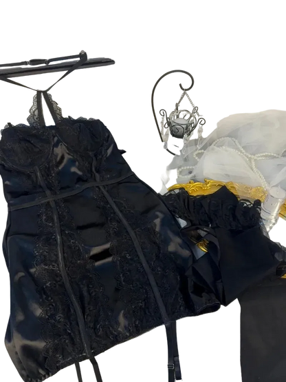 Black lace top on a hanger with a white background