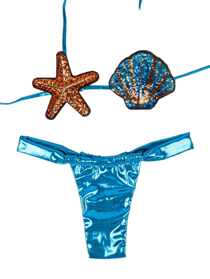Blue bikini bottom with starfish and shell decorations on a beige background