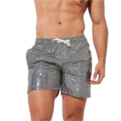 Silver holographic swim shorts with drawstring, perfect for a stylish beach day at the resort.