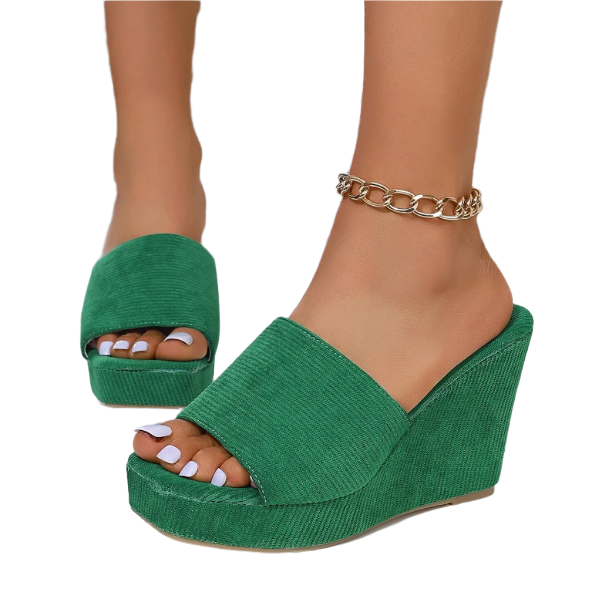 Green wedge sandals worn with a glittery background