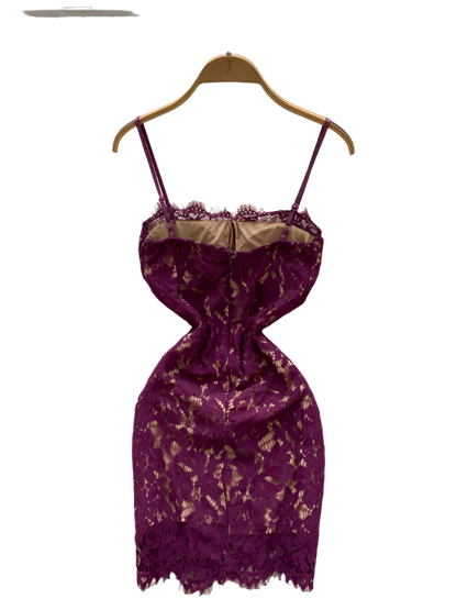 Purple lace dress on a hanger with decorative background
