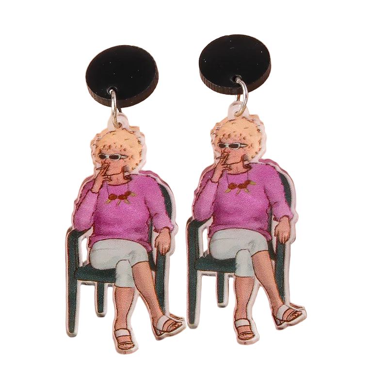 Earrings with a design of a person in a pink sweater sitting on a chair, on a beige background.