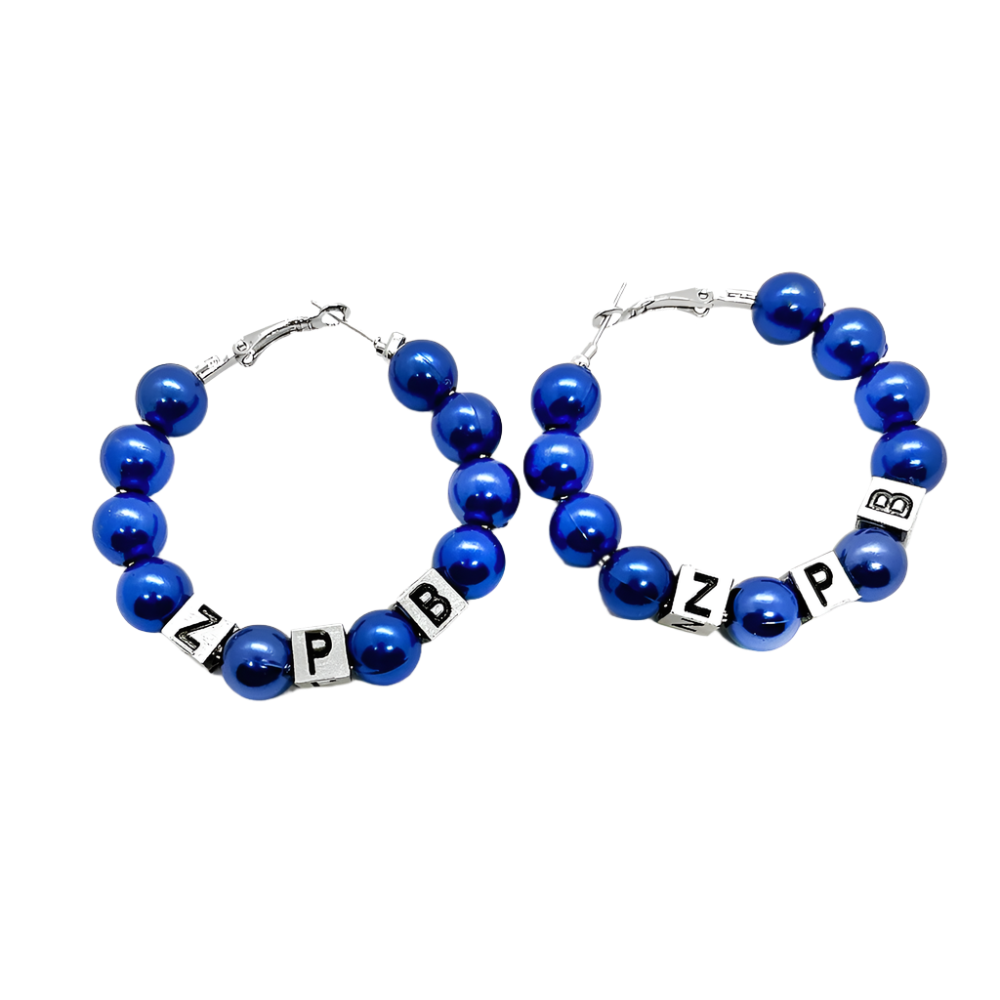 Pair of blue beaded hoop earrings with letter beads on a white background