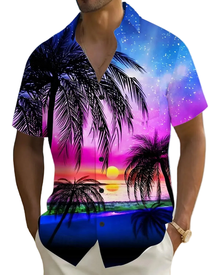 Person wearing a colorful beach-themed shirt with palm trees and sunset design on a beach.