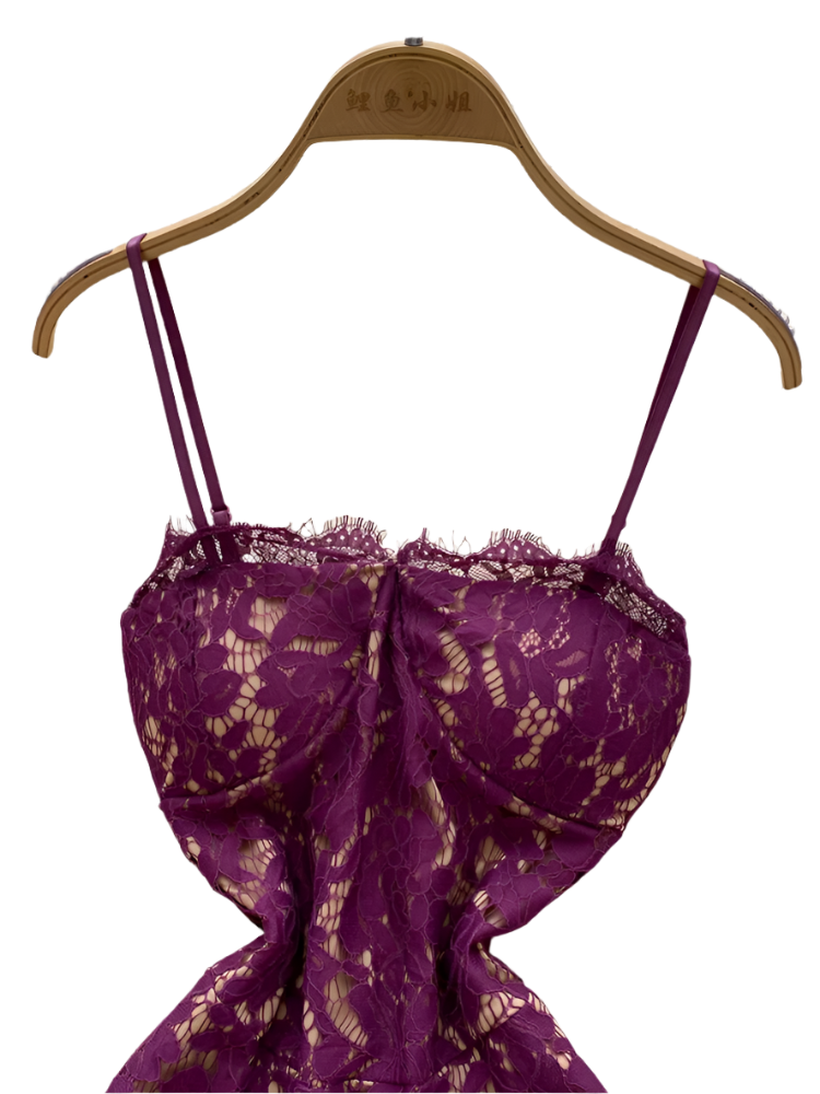 Purple lace dress on a hanger against a white textured background