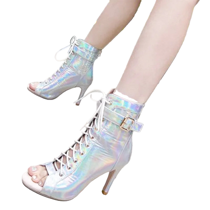 Holographic high-heeled boots worn by a person on a pavement.