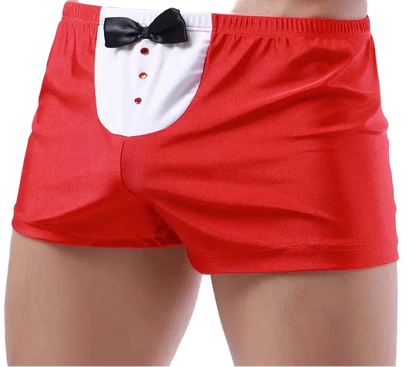 Red boxer briefs with a white tuxedo-style front panel, black bow tie, and red buttons, shown on a cropped male model against a white studio background.