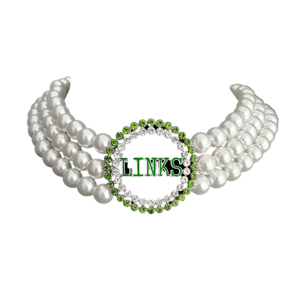 Pearl necklace with a green and silver 'LINKS' pendant on a black background