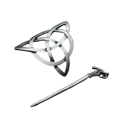 Silver Celtic knot brooch and hairpin on a dark textured surface