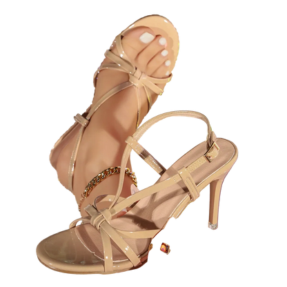 Beige high-heeled sandal with thin straps held against a glittery multicolor background