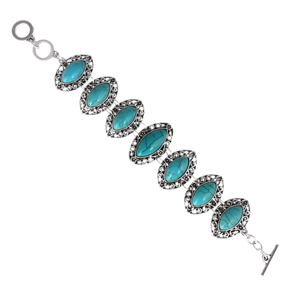 Bracelet with turquoise stones and silver accents on a white background