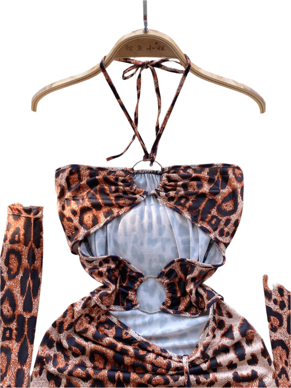 A leopard print dress with cut-out sections and ruching. It features a halter neck and matching arm sleeves, creating a wild and daring style.