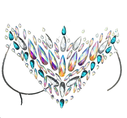 A sheet of clear and iridescent rhinestones arranged in a symmetrical heart or floral crown pattern on a white backing card, photographed on a dark gray background. A small clear plastic container of adhesive or backing material sits at the lower left.