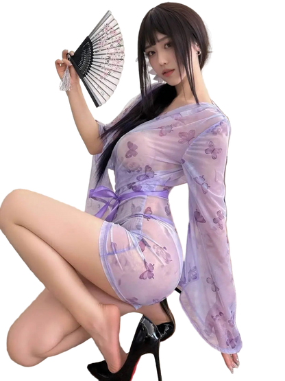 Woman in a sheer, light purple outfit with butterfly patterns in an indoor setting.