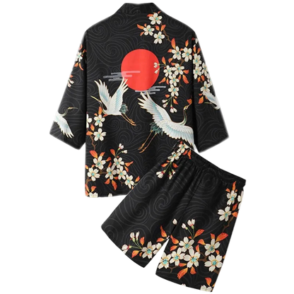 Black kimono-style outfit with crane and floral patterns on a white background