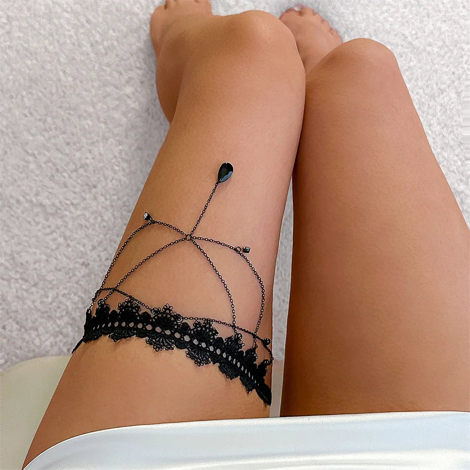 Black lace leg accessory worn by a person on a textured surface