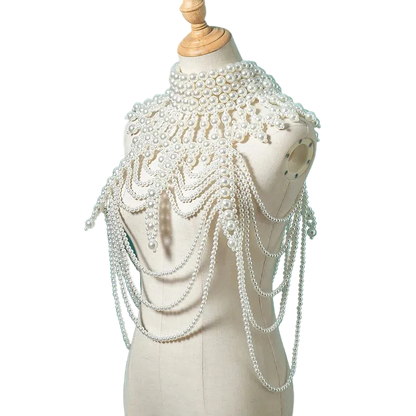 Pearl embellished headpiece on a mannequin against a teal background