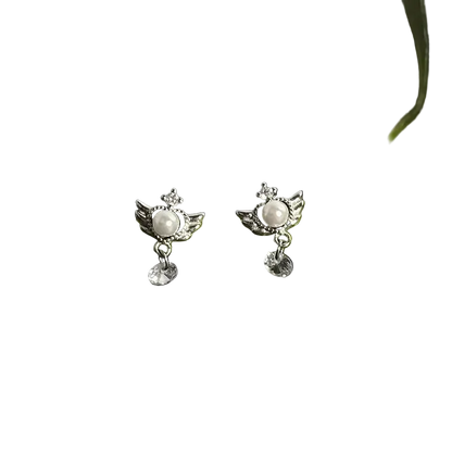 Pair of silver earrings with a central gemstone on a green stem against a dark background