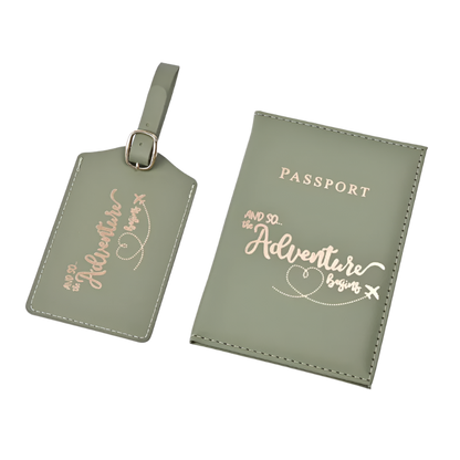 A passport holder and luggage tag set with the phrase "And so the adventure begins" in elegant script. The design is sleek and stylish, perfect for travel.