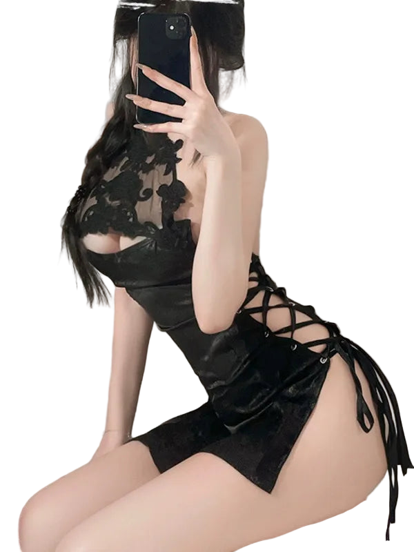Person wearing a black lace dress with a blurred background
