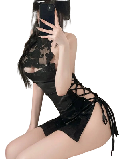 Person wearing a black lace dress with a blurred background