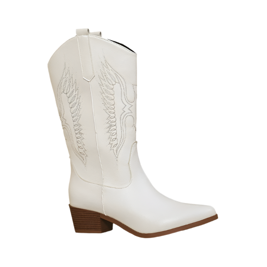 White cowboy boot with brown block heel on a beige background