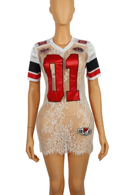 A sheer white lace mini dress styled like a football jersey, displayed on a female mannequin. The dress features a white lace base with a red and black number '01' on the front, red shoulder patches, and a small '1997' patch near the bottom hem.