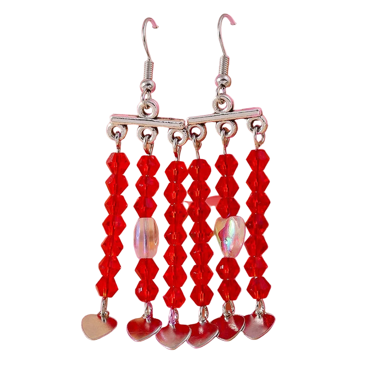 Red beaded earrings with silver hearts on a pink background