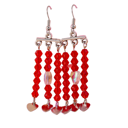 Red beaded earrings with silver hearts on a pink background