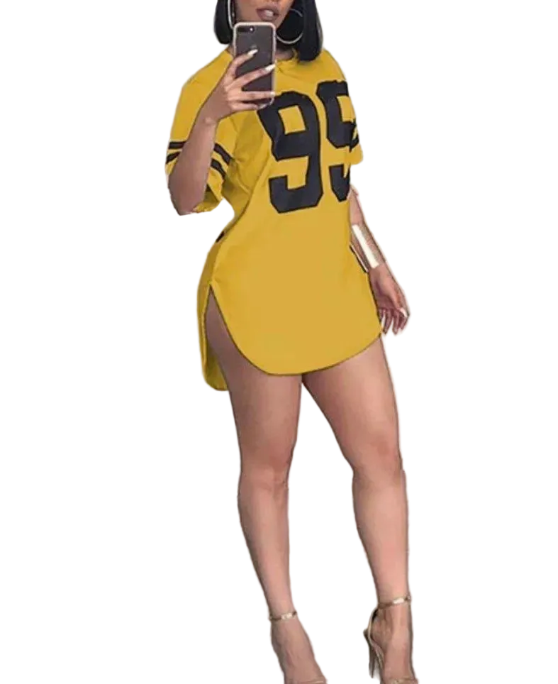 Person wearing a yellow oversized t-shirt with the number 95 in black, standing indoors.