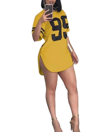Person wearing a yellow oversized t-shirt with the number 95 in black, standing indoors.