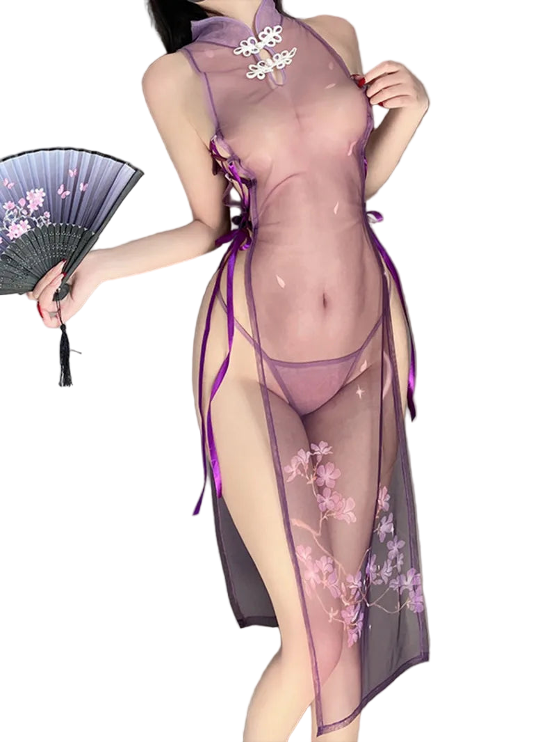 Person wearing a sheer purple outfit with floral designs, holding a fan.