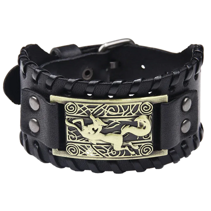 Black leather bracelet with a gold dragon emblem on a white background