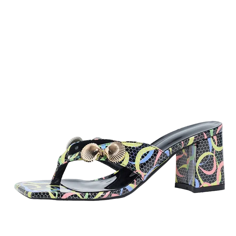 A single women's heeled thong sandal with a colorful abstract print on a black base, featuring a chunky block heel and two metallic shell-shaped embellishments on the strap, shown against a plain white background.
