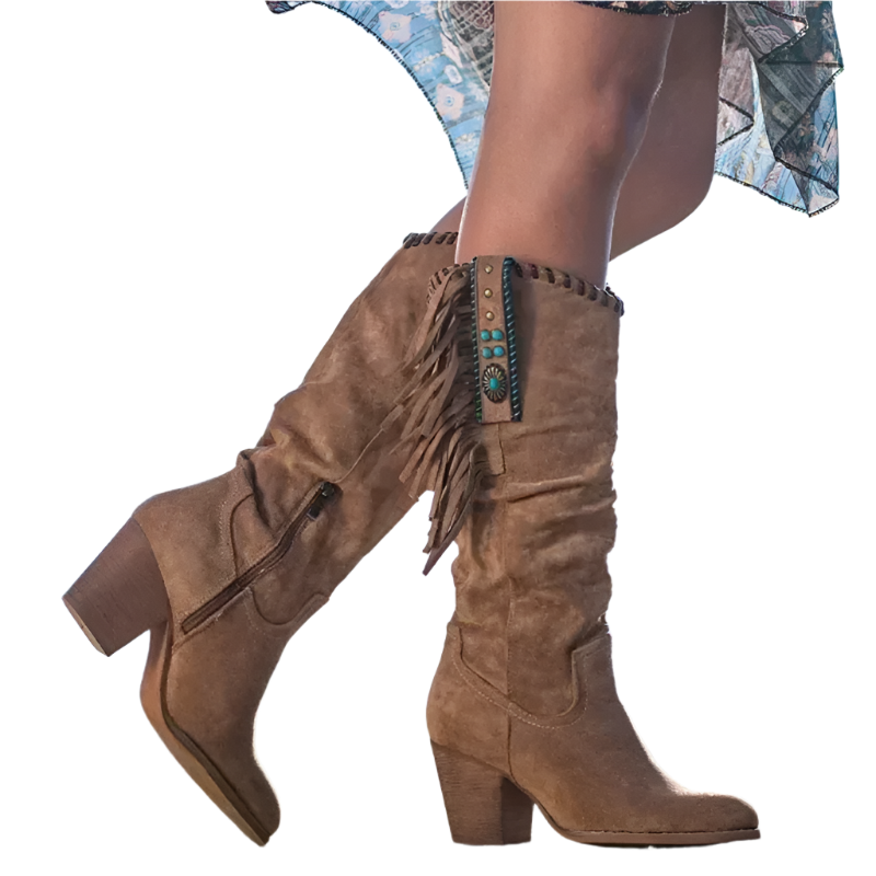 Brown suede knee-high boots with fringe and turquoise details worn by a person against a blue sky.