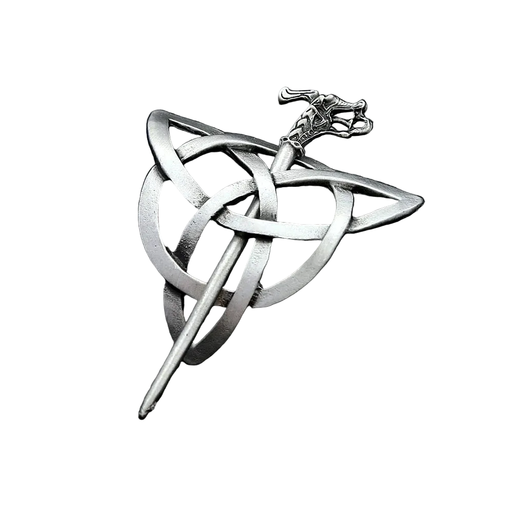 Silver Celtic knot brooch on a dark textured surface