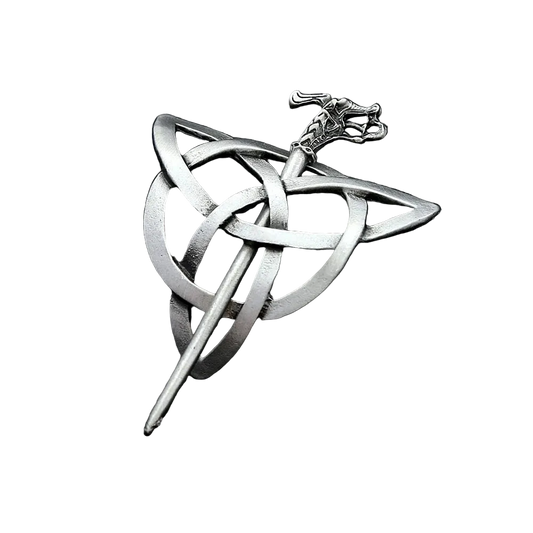 Silver Celtic knot brooch on a dark textured surface