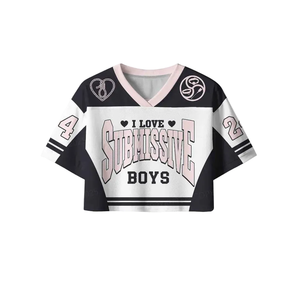 A cropped V-neck jersey-style top with a black, white, and light pink color scheme. The front features the text 'I LOVE SUBMISSIVE BOYS' with heart icons, and the sleeves display the numbers 4 and 2.