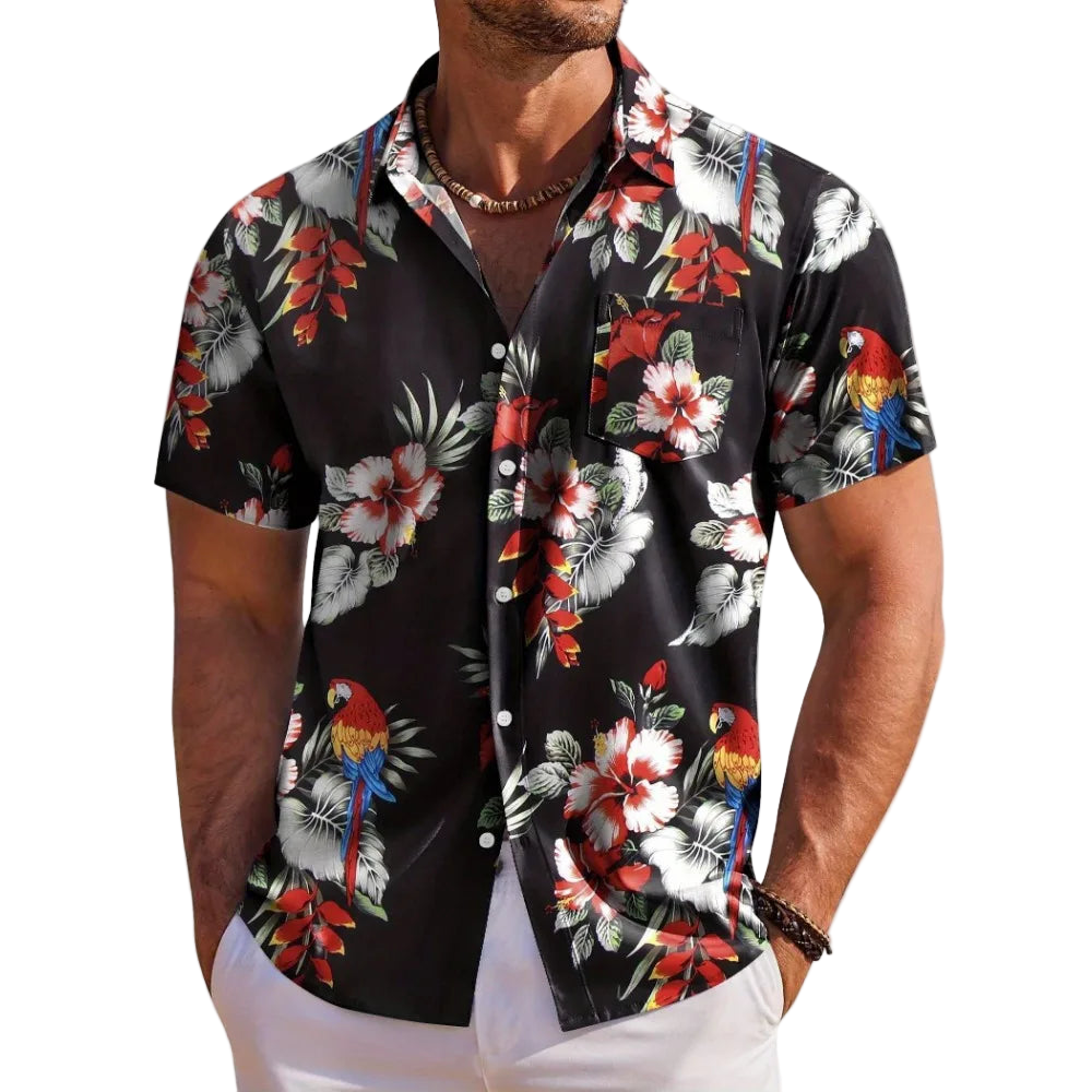 Man wearing a black floral shirt with parrot design on a white background